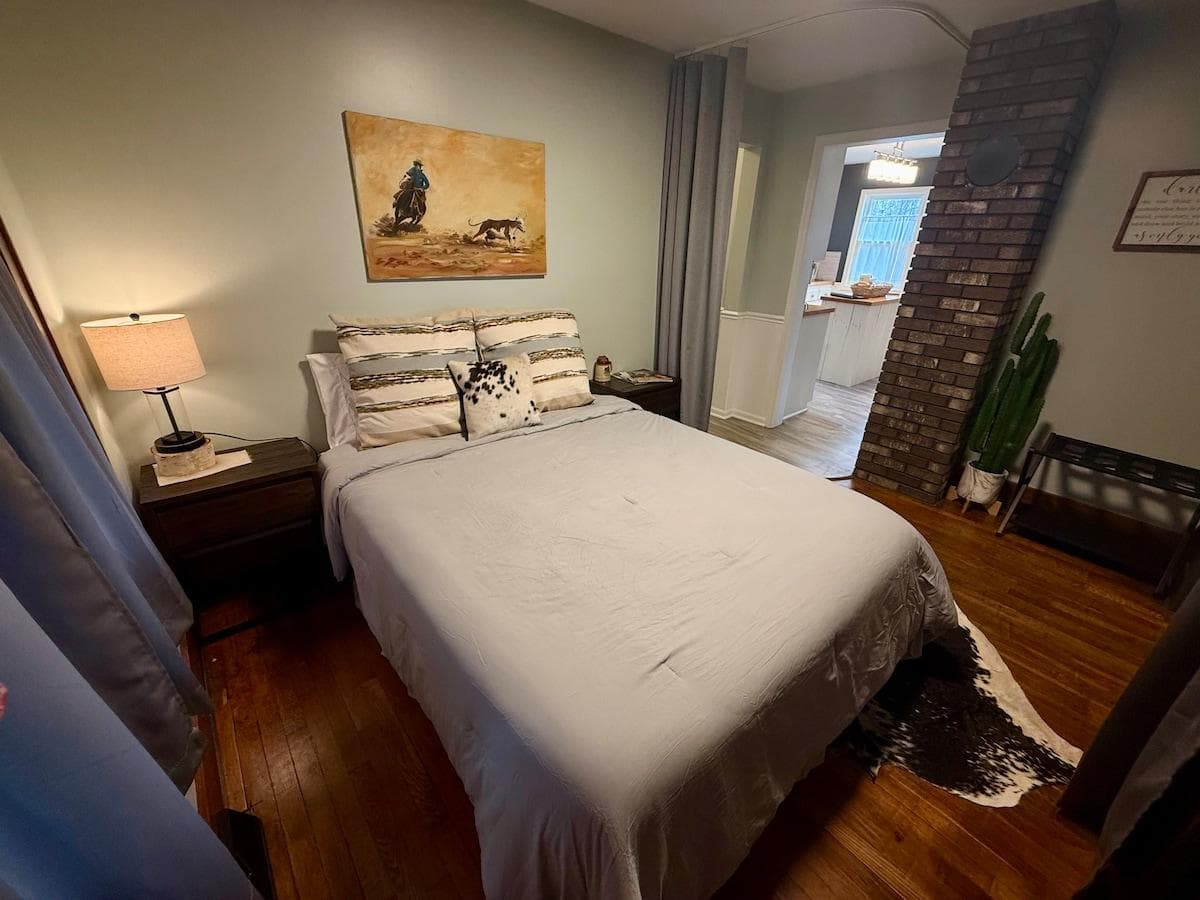 Main floor bedroom with queen bed with privacy curtains.