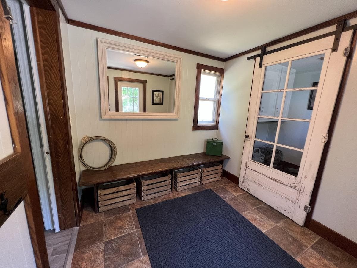 Home entry way, space for coats and bench for putting on and removing shoes.