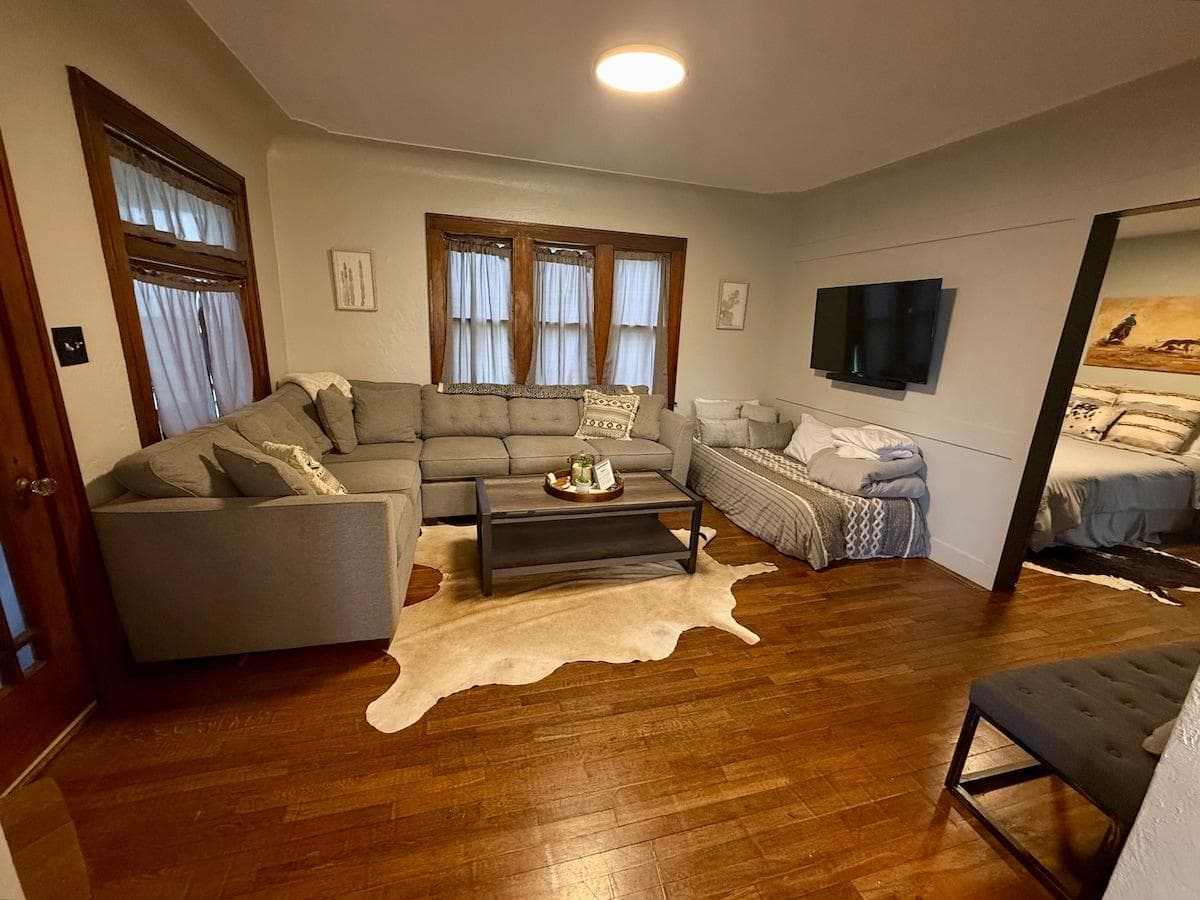 Main floor living room with twin bed and couch for sleeping.
